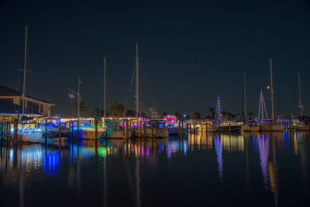 Boats lit up with Christmas lights parked at the dock in Florida