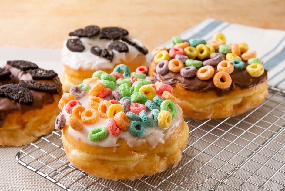 donuts with fruit loops, oreos and chocolate frosting on them. 