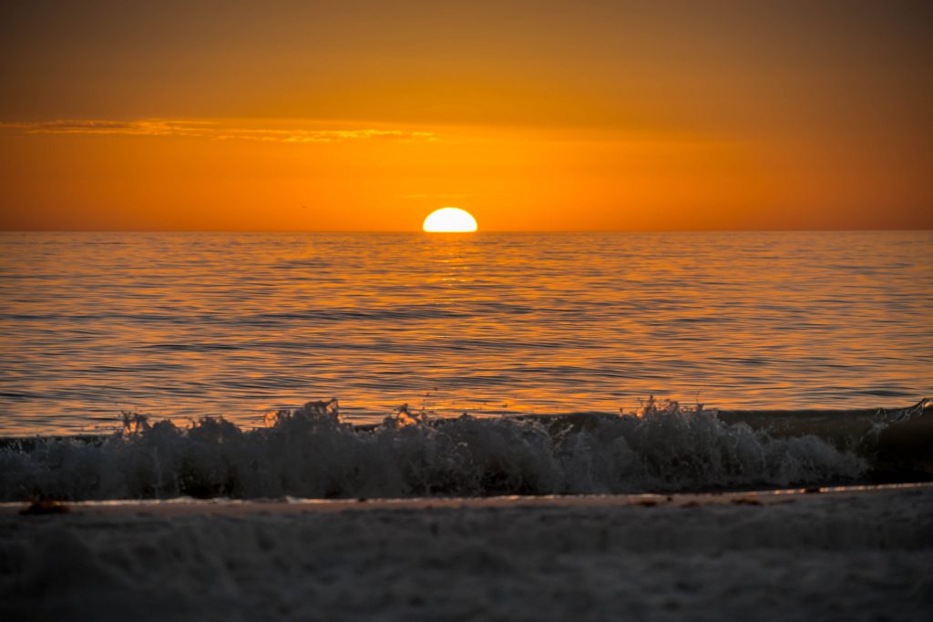 A very romantic shoreside sunset with orange and blue cloudy sky in Anna Maria Key